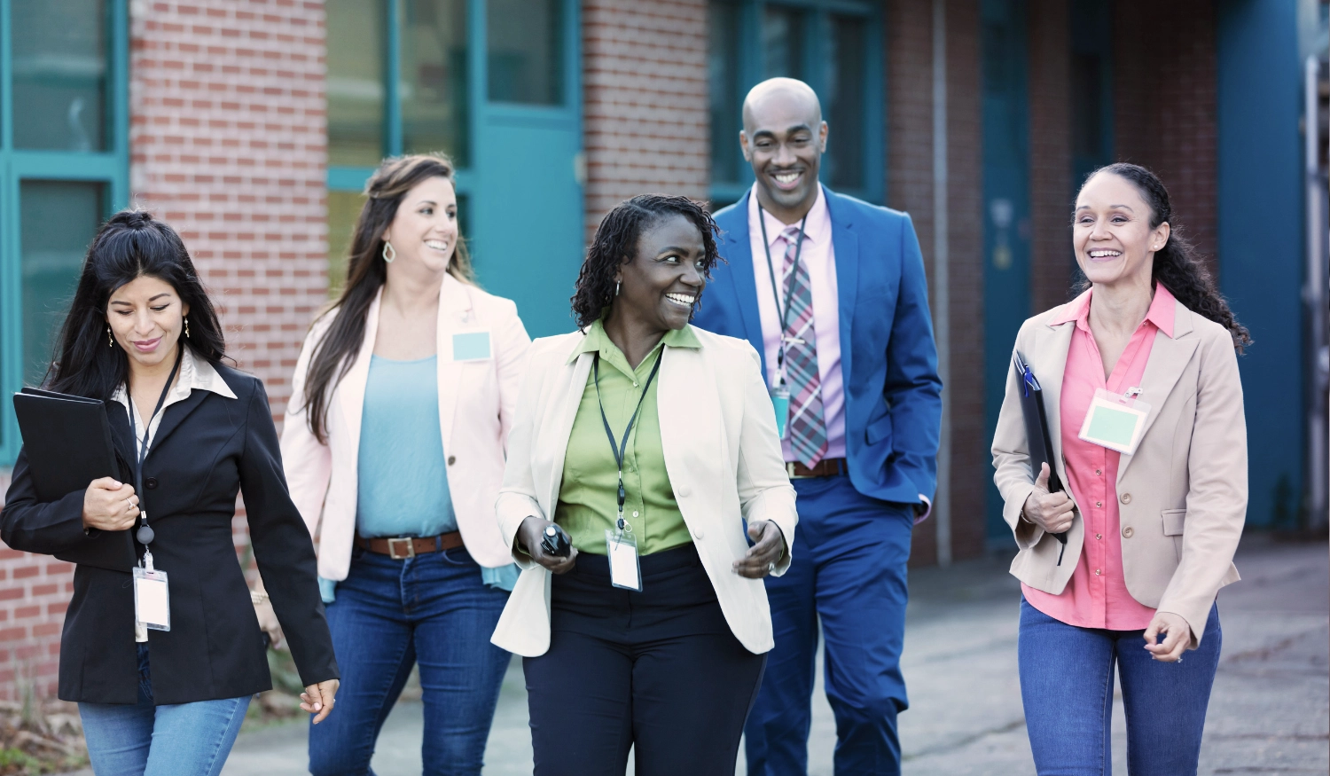 diverse group of lawyers in professional attire walking outside of a building